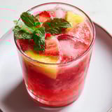 Close-up of a DIY fruit refresher drink with fresh strawberries, perfect for a hot day.
