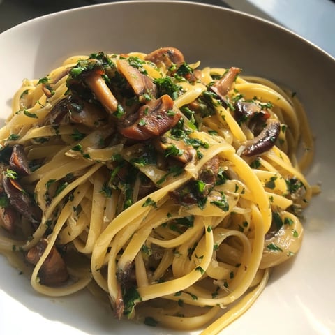 Fragrant Pasta Aglio e Olio with Mushrooms, glistening with olive oil and sauteed mushrooms.