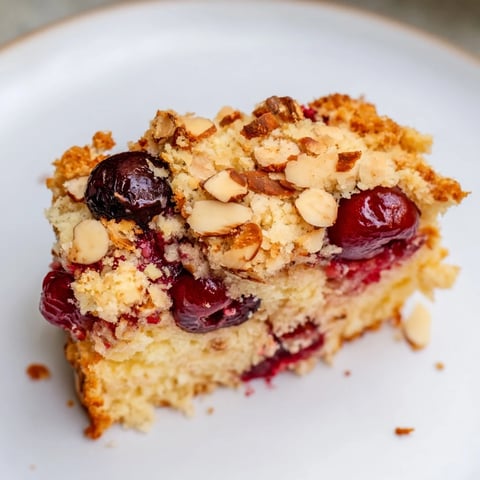 Golden streusel tops a slice of Classic Firefighter Cake, a German dessert with juicy cherries.