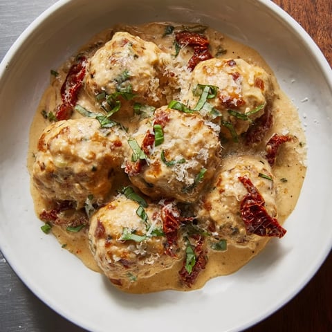 Marry Me Chicken Meatballs, swimming in a creamy, sun-dried tomato sauce, ready for serving over pasta.