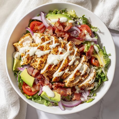Crispy bacon chicken salad with juicy chicken, crunchy bacon, and fresh greens, ready to enjoy.