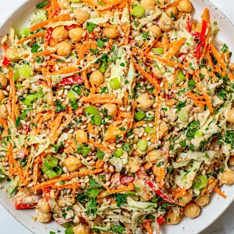 Vibrant Fiber-Forward Chickpea Salad, showcasing colorful shredded veggies and creamy tahini dressing.
