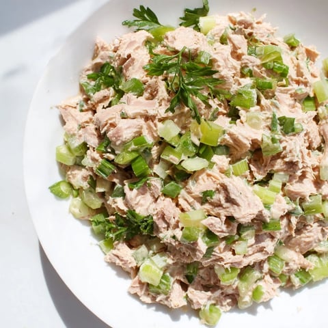Close-up of vibrant Spicy Zesty Tuna Salad with fluffy flakes and crisp scallions.