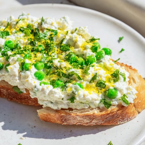 Vibrant Pea & Mint Ricotta Toast with creamy whipped ricotta and fresh mint on golden sourdough slices.