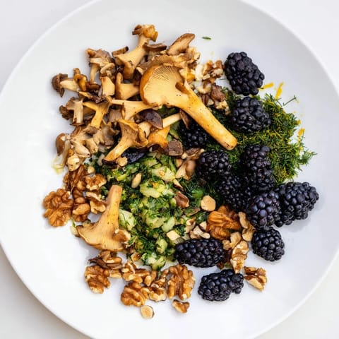 Visually appealing Northwest Forest Forager appetizer with earthy mushrooms, toasted nuts, and berries.