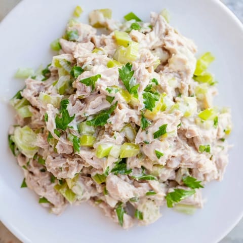 Platter of Spicy Zesty Tuna Salad served on toasted bread with fresh lemon.