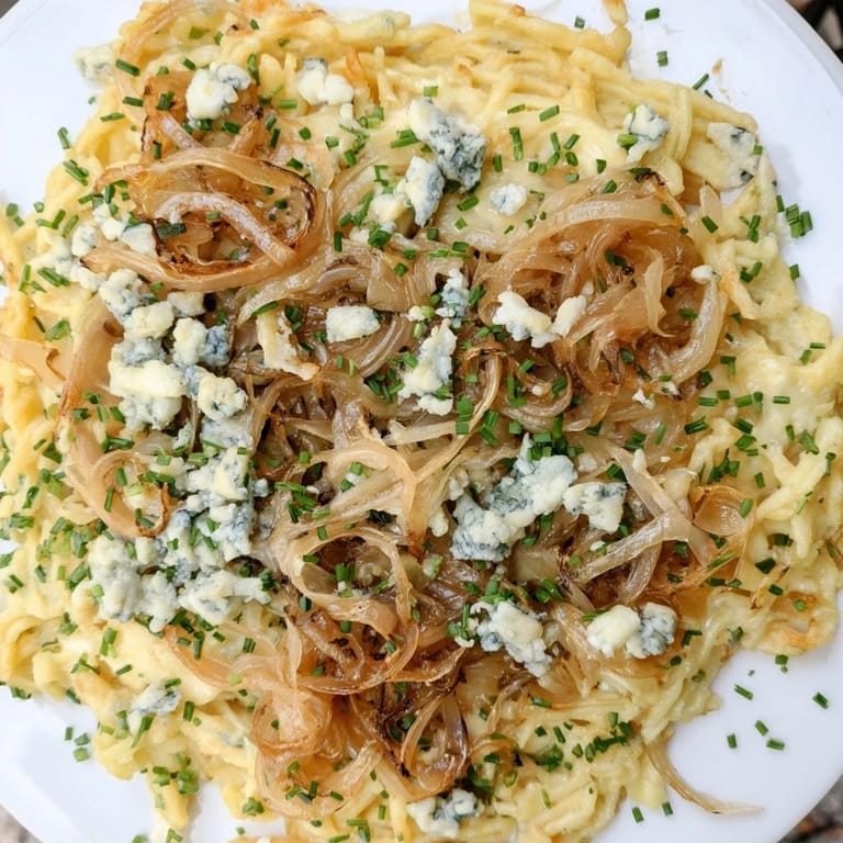 Golden, bubbling Käse-Spätzle Luxus with Gruyère cheese and toppings, a satisfying main course.