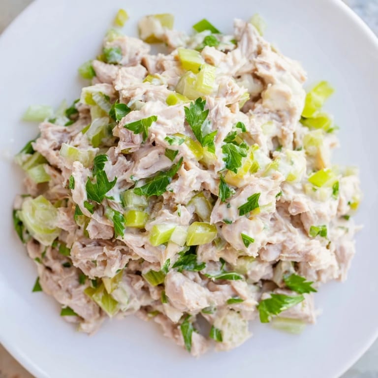 Platter of Spicy Zesty Tuna Salad served on toasted bread with fresh lemon.
