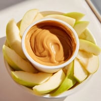 Crisp apple slices artfully arranged around a creamy caramel dip for dipping.